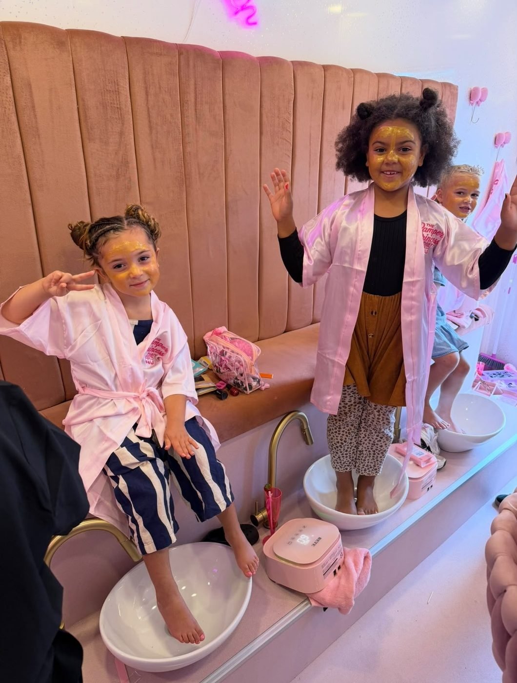 Girls enjoying face masks and foot spa on the bus